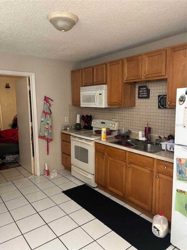 3265 51st Avenue Dr W, Bradenton, FL 34207 - kitchen with white appliances, light countertops, and brown cabinets