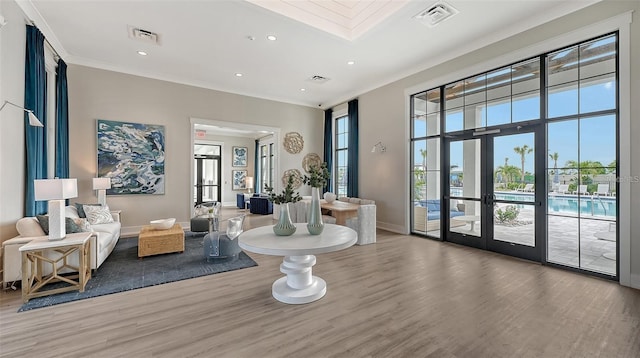17502 Savory Mist Cir, Bradenton, FL 34211 - living room with wood finished floors, ornamental molding, french doors, recessed lighting, and baseboards