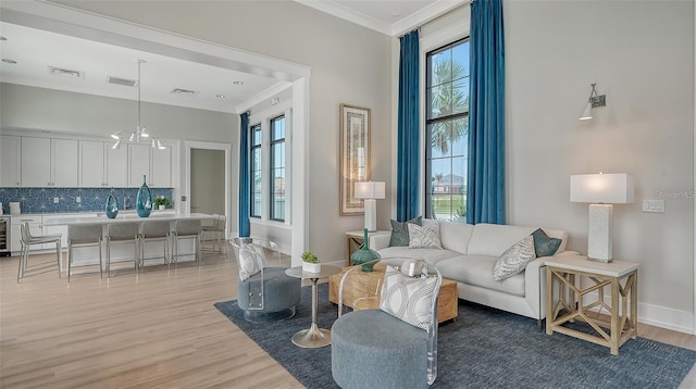 17502 Savory Mist Cir, Bradenton, FL 34211 - living area with light wood-type flooring, crown molding, plenty of natural light, and baseboards