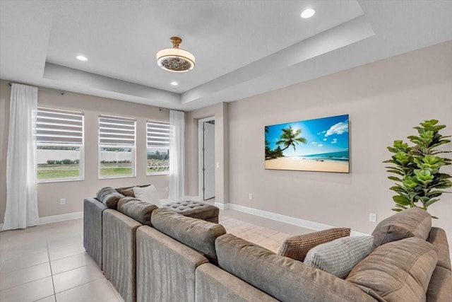 17502 Savory Mist Cir, Bradenton, FL 34211 - living room featuring a tray ceiling, baseboards, light tile patterned floors, and recessed lighting