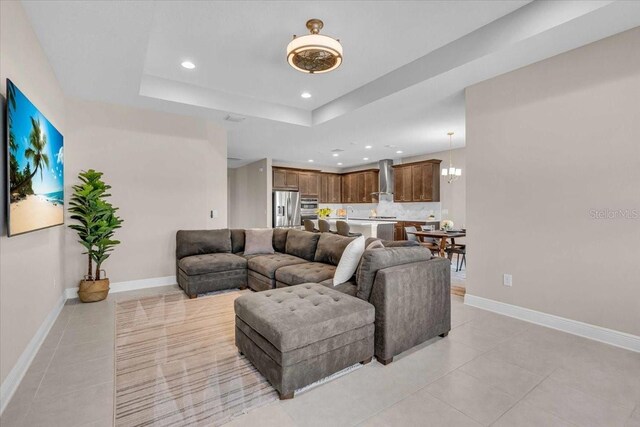 17502 Savory Mist Cir, Bradenton, FL 34211 - living area with light tile patterned floors, recessed lighting, baseboards, and a tray ceiling