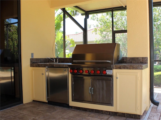 406 Petrel Trl, Bradenton, FL 34212 - kitchen featuring stainless steel fridge, a wealth of natural light, and stone tile flooring