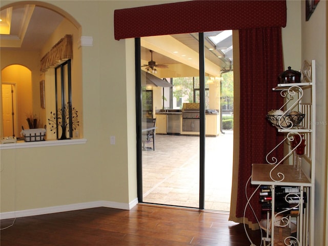 406 Petrel Trl, Bradenton, FL 34212 - doorway with arched walkways, hardwood / wood-style floors, a ceiling fan, and baseboards