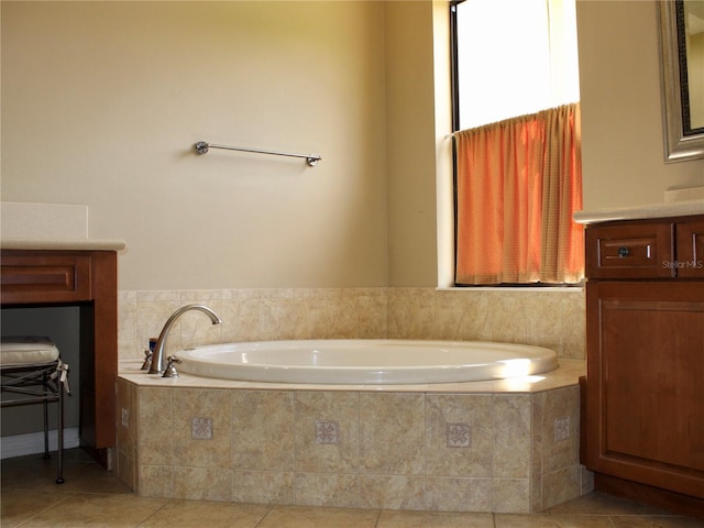 406 Petrel Trl, Bradenton, FL 34212 - bathroom featuring a garden tub, tile patterned floors, vanity, and a healthy amount of sunlight