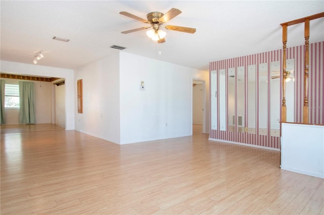 1315 Bottlebrush Dr, Bradenton, FL 34208 - empty room featuring light wood-type flooring, a textured ceiling, visible vents, and a ceiling fan