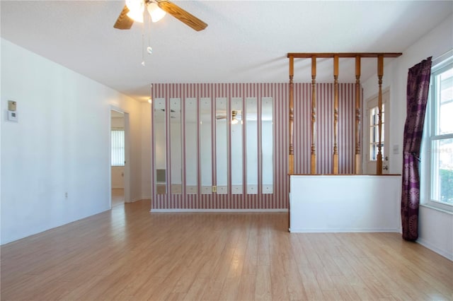 1315 Bottlebrush Dr, Bradenton, FL 34208 - empty room with a wealth of natural light, a textured ceiling, ceiling fan, and wood finished floors