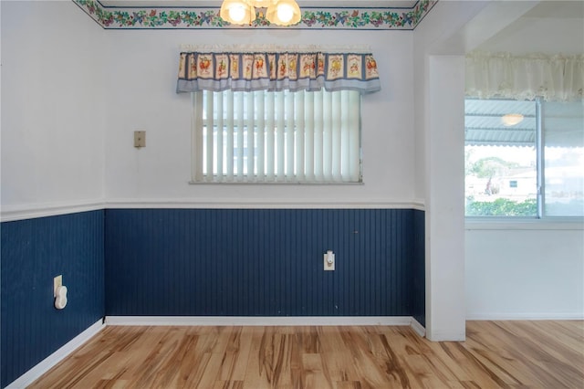 1315 Bottlebrush Dr, Bradenton, FL 34208 - spare room with a wainscoted wall and wood finished floors