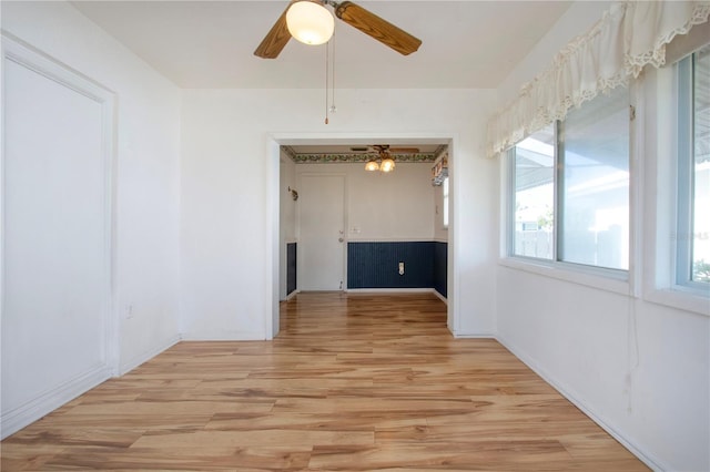 1315 Bottlebrush Dr, Bradenton, FL 34208 - empty room featuring light wood finished floors, ceiling fan with notable chandelier, and baseboards