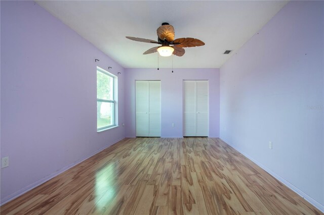 1315 Bottlebrush Dr, Bradenton, FL 34208 - unfurnished bedroom with baseboards, visible vents, two closets, and light wood-type flooring