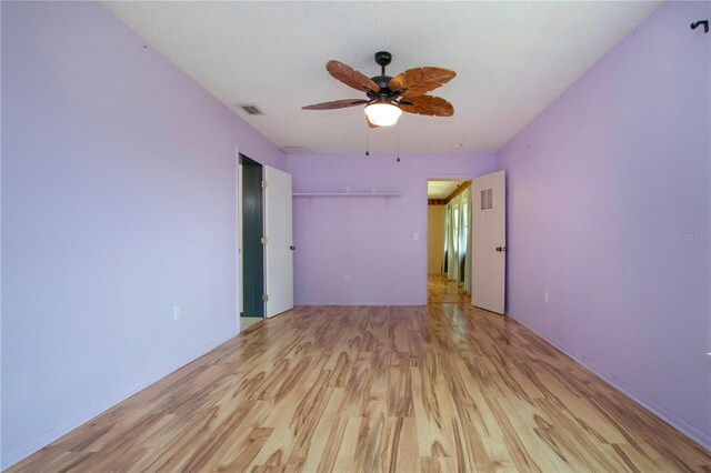 1315 Bottlebrush Dr, Bradenton, FL 34208 - unfurnished room featuring a textured ceiling, visible vents, a ceiling fan, and light wood finished floors