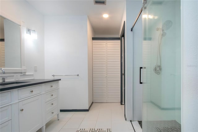 1315 Bottlebrush Dr, Bradenton, FL 34208 - full bathroom with vanity, visible vents, tile patterned floors, and walk in shower