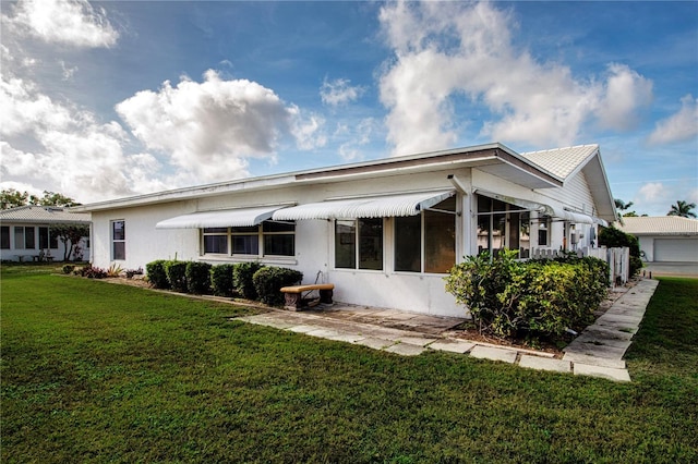 1315 Bottlebrush Dr, Bradenton, FL 34208 - rear view of house featuring a lawn and stucco siding