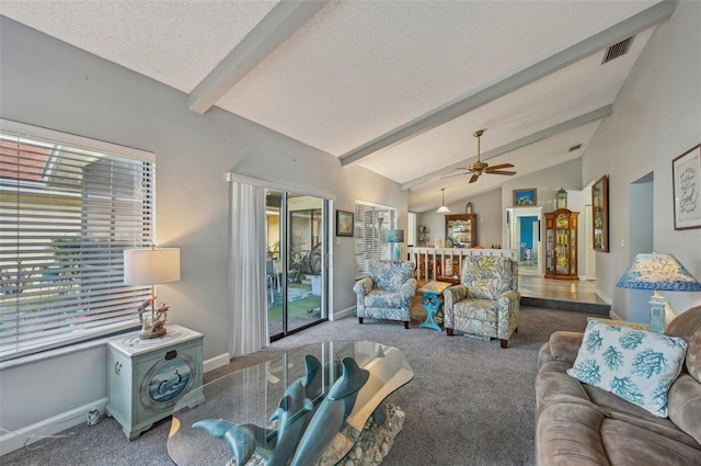 living room with lofted ceiling with beams, carpet, baseboards, a textured ceiling, and ceiling fan
