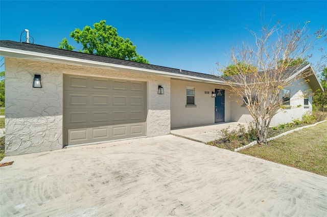 ranch-style home with driveway, stucco siding, and an attached garage