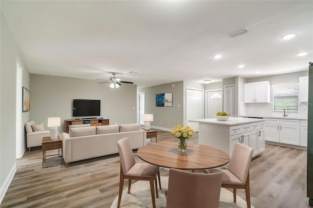 dining space with light wood finished floors, recessed lighting, baseboards, and a ceiling fan
