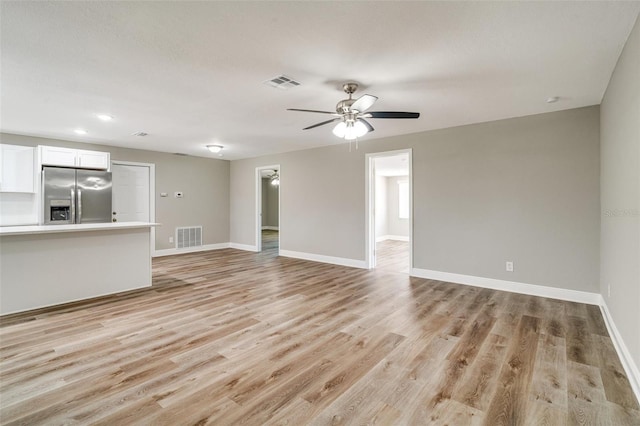 unfurnished living room featuring light wood-style floors, baseboards, a ceiling fan, and recessed lighting