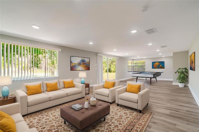 living area featuring recessed lighting, wood finished floors, and baseboards