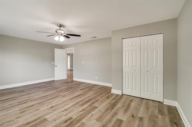 unfurnished bedroom with light wood finished floors, baseboards, a closet, and ceiling fan