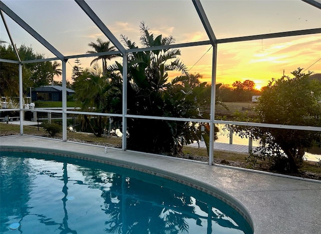 4219 Eastlake Ct, Port Charlotte, FL 33948 - pool at dusk with an outdoor pool, a patio area, and glass enclosure