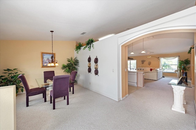 4219 Eastlake Ct, Port Charlotte, FL 33948 - dining area with baseboards, visible vents, arched walkways, light colored carpet, and ceiling fan with notable chandelier