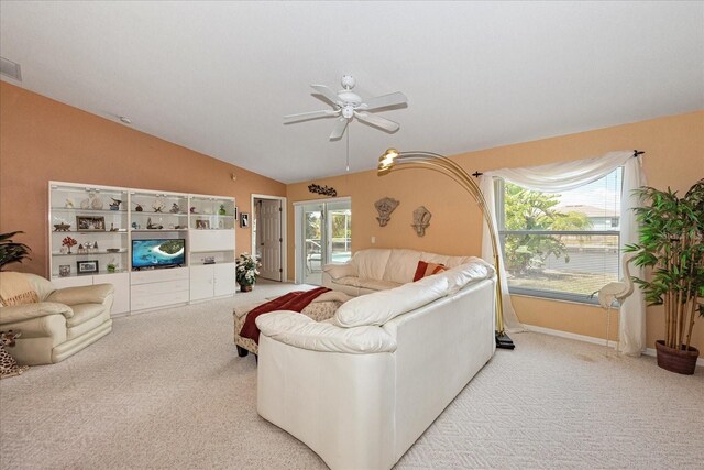 4219 Eastlake Ct, Port Charlotte, FL 33948 - living area with visible vents, a ceiling fan, vaulted ceiling, and carpet floors