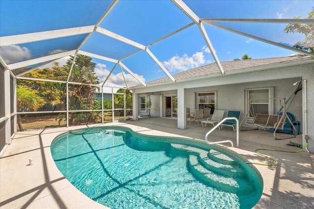 4219 Eastlake Ct, Port Charlotte, FL 33948 - outdoor pool featuring glass enclosure and a patio