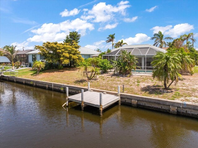 4219 Eastlake Ct, Port Charlotte, FL 33948 - dock area with a lawn, glass enclosure, and a water view