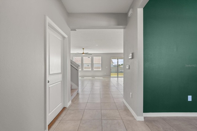 4405 Stargrazer Ct, Palmetto, FL 34221 - corridor with light tile patterned flooring, baseboards, and stairway