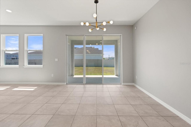 4405 Stargrazer Ct, Palmetto, FL 34221 - spare room featuring a chandelier, light tile patterned flooring, and baseboards