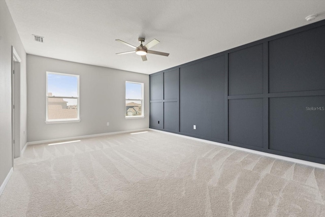 4405 Stargrazer Ct, Palmetto, FL 34221 - unfurnished bedroom with light carpet, a decorative wall, baseboards, and ceiling fan