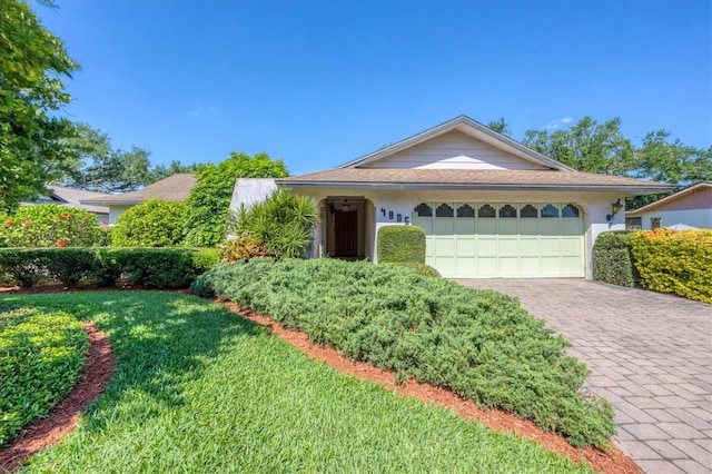 4806 Huntleigh Dr, Sarasota, FL 34233 - single story home with a garage, stucco siding, decorative driveway, and a front lawn