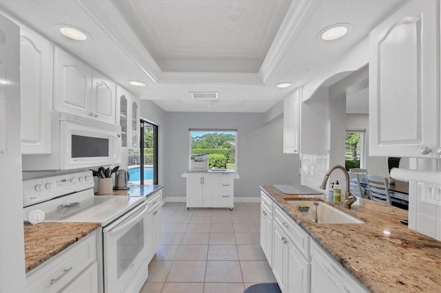 4806 Huntleigh Dr, Sarasota, FL 34233 - kitchen featuring a sink, a raised ceiling, white appliances, and recessed lighting