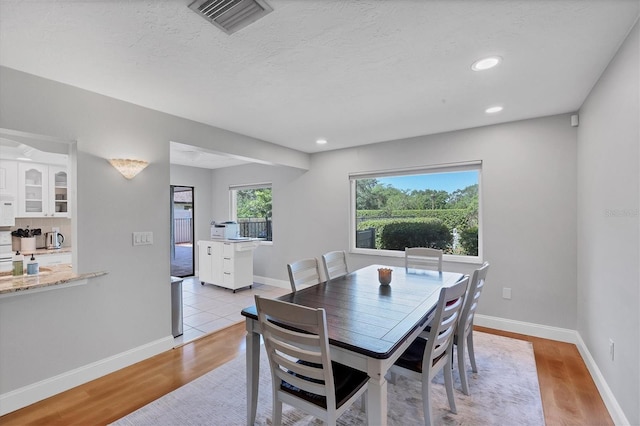4806 Huntleigh Dr, Sarasota, FL 34233 - dining space featuring recessed lighting, light wood finished floors, visible vents, and baseboards