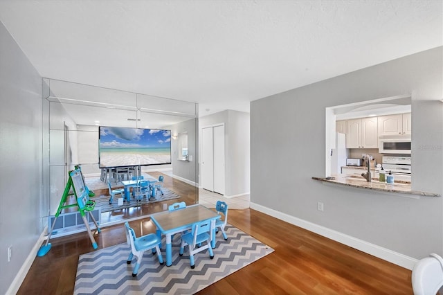 4806 Huntleigh Dr, Sarasota, FL 34233 - dining space featuring baseboards and wood finished floors