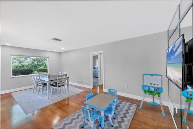 4806 Huntleigh Dr, Sarasota, FL 34233 - dining area featuring wood finished floors, baseboards, and visible vents