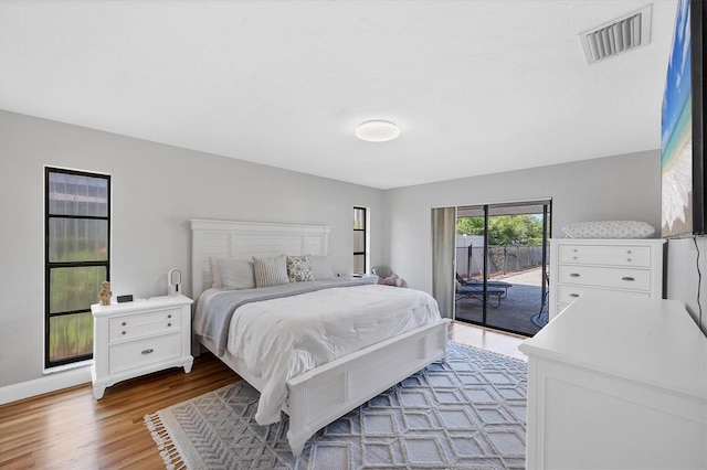 4806 Huntleigh Dr, Sarasota, FL 34233 - bedroom with visible vents, access to exterior, and wood finished floors