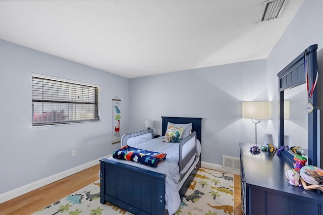 4806 Huntleigh Dr, Sarasota, FL 34233 - bedroom featuring visible vents, baseboards, and light wood-type flooring