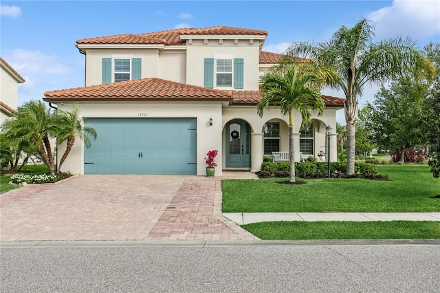 13721 Saw Palm Creek Trl, Lakewood Ranch, FL 34211 - mediterranean / spanish-style house featuring a tile roof, a front yard, decorative driveway, and a garage