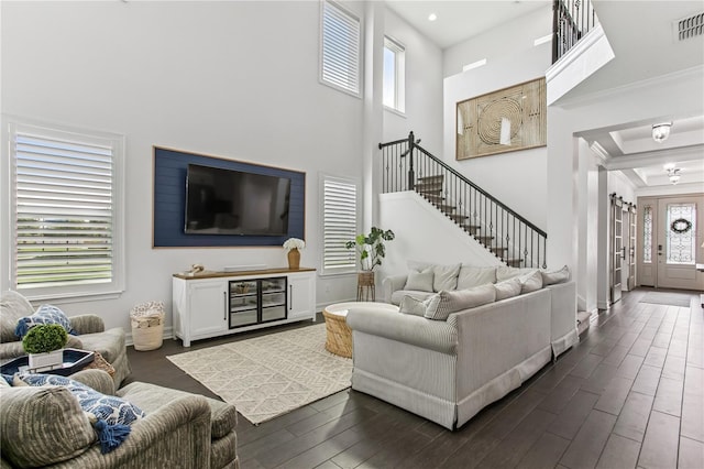 13721 Saw Palm Creek Trl, Lakewood Ranch, FL 34211 - living area with crown molding, stairs, baseboards, dark wood-style floors, and visible vents