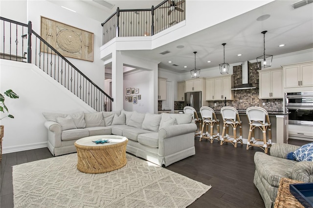 13721 Saw Palm Creek Trl, Lakewood Ranch, FL 34211 - living area featuring dark wood-type flooring, stairs, a towering ceiling, and visible vents