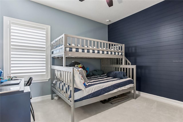 13721 Saw Palm Creek Trl, Lakewood Ranch, FL 34211 - bedroom featuring baseboards, a ceiling fan, wooden walls, and carpet
