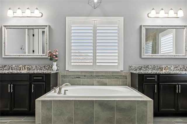 13721 Saw Palm Creek Trl, Lakewood Ranch, FL 34211 - bathroom featuring a sink, two vanities, and a garden tub