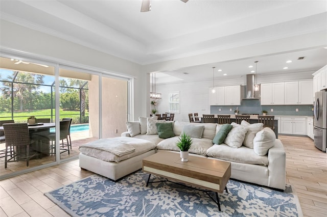 living area featuring ceiling fan, light wood-type flooring, and recessed lighting