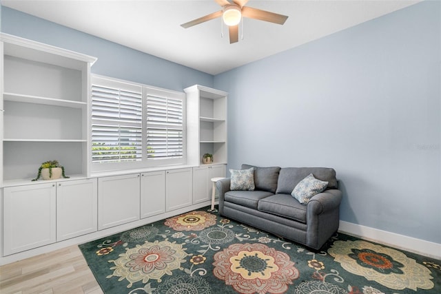 living area featuring light wood finished floors and ceiling fan