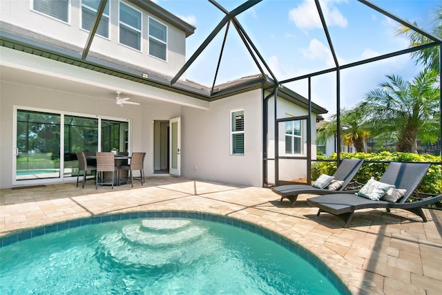 outdoor pool featuring a lanai, a patio area, and ceiling fan