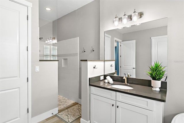 full bath with a walk in shower and vanity
