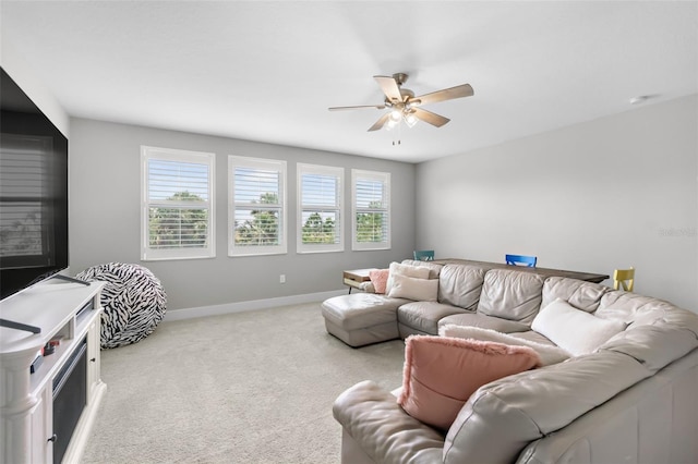 living area with a ceiling fan, carpet flooring, and baseboards