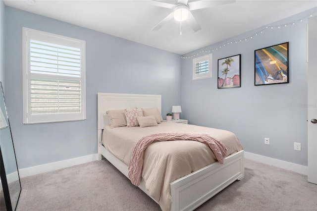bedroom with ceiling fan, carpet flooring, and baseboards