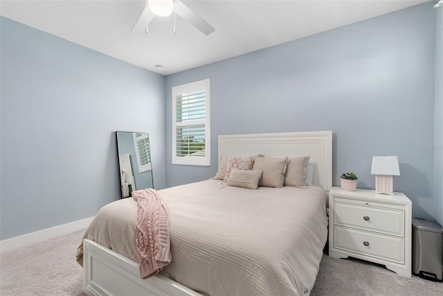 bedroom with ceiling fan, carpet flooring, and baseboards