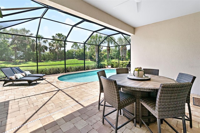 pool featuring a patio area and glass enclosure